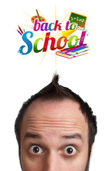 Young man with BACK TO SCHOOL sign over his head — Stock Photo, Image
