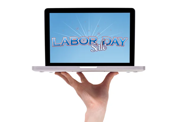Eine männliche Hand hält einen Laptop mit einem Schild zum Tag der Arbeit — Stockfoto