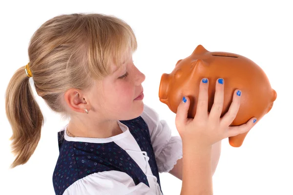 Little girl kissing piggy bank — Stock Photo, Image