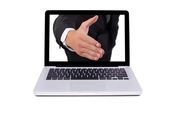 Hand coming out from the screen of the laptop — Stock Photo, Image