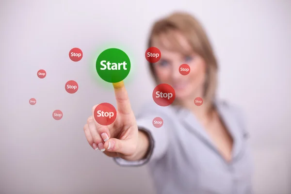 Woman pressing start and stop button — Stock Photo, Image