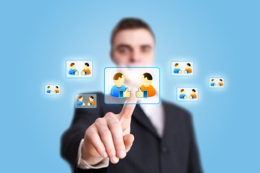 Businessman hand pressing Social network icon 2 clipart