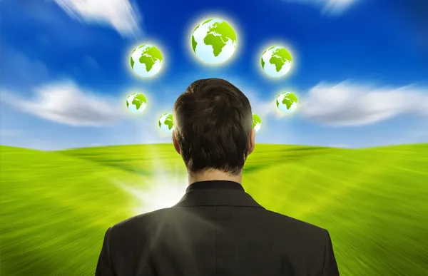 Businessman with ECO icons floating around his head — Stock Photo, Image