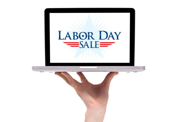 A male hand holding a laptop with a labor day sign — Stock Photo, Image