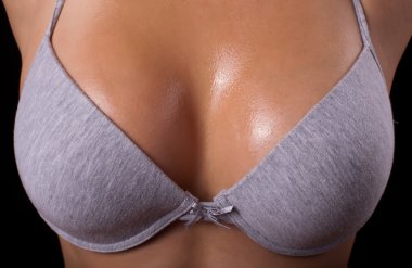 Breast in uplift on a black background 2 clipart