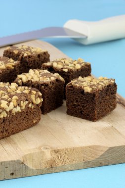 Chocolate brownies with cracked peanuts on top clipart