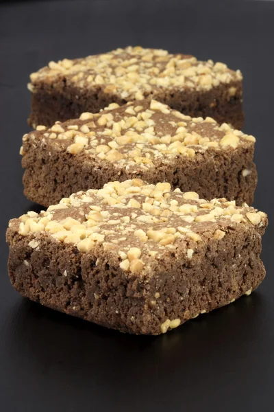 stock image Chocolate brownies with cracked peanuts on top