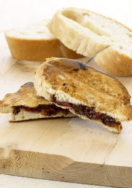 Delicious rustic hazelnut spread and jelly sandwich — Stock Photo, Image