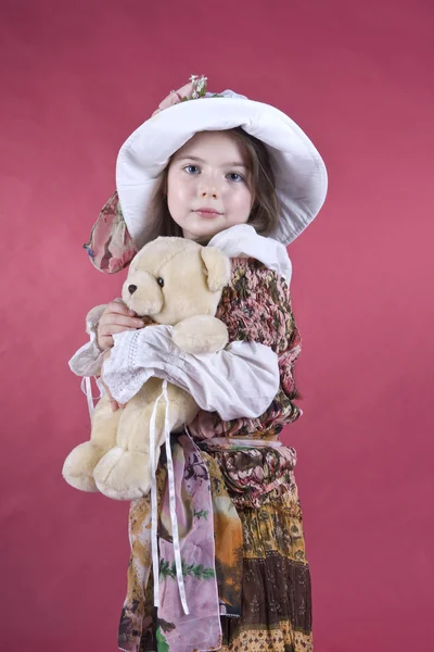 Portrait of the little girl, with a toy in hands — Stock Photo, Image