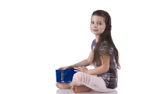 Little girl sitting on the floor with a blue gift box — Stock Photo, Image