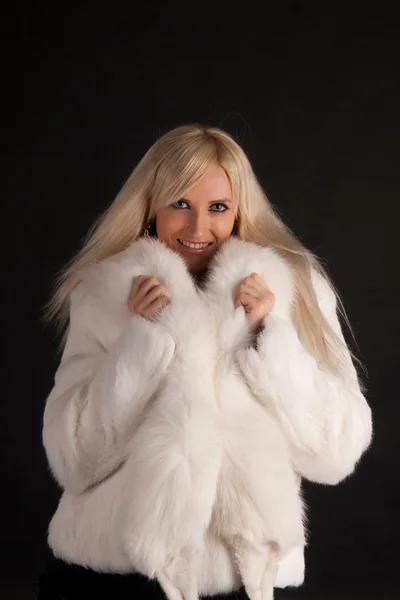 The glamour blonde in a warm white fur coat — Stock Photo, Image