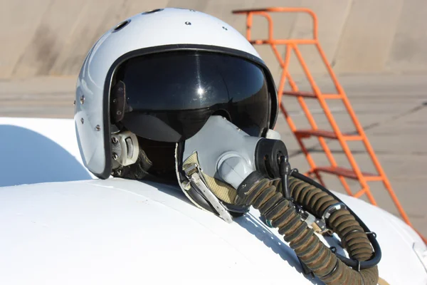 Protective helmet of the pilot against the plane — Stock Photo, Image