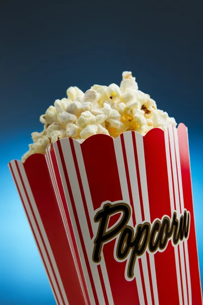 Popcorn over blue background — Stock Photo, Image