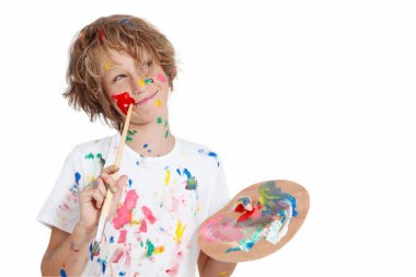 Child with paint brush planning mischief