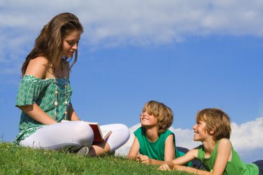 Mother reading to children clipart