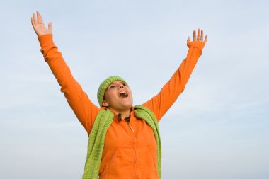 Kid with arms raised singing or faith and praise clipart