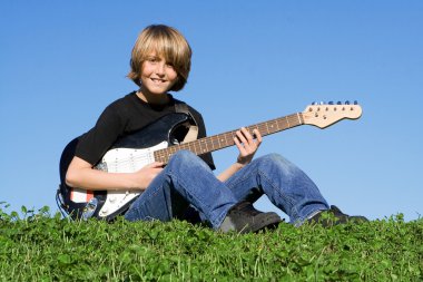 Child guitarist, young musician playing guitar clipart