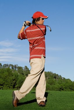 Golfer playing game of golf clipart