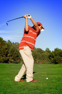 Young man swinging golf club clipart