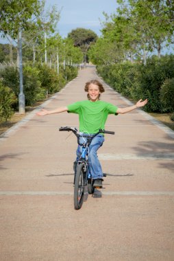 Confident child riding bike or bicycle clipart