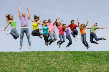 Happy smiling diverse mixed race group jumping