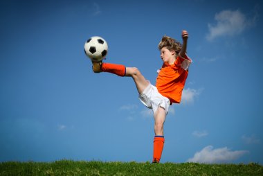 Child kicking playing football clipart