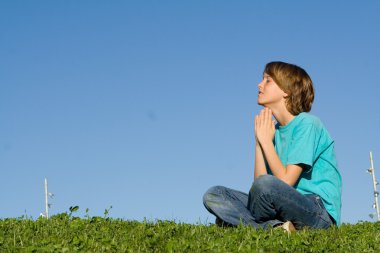 Christianity, child saying prayers outdoors clipart