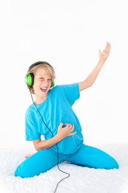 Young teen kid playing air guitar clipart