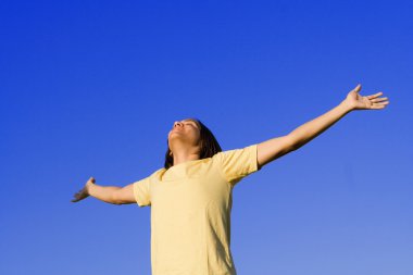 Young man holding arms out in faith and prayer clipart