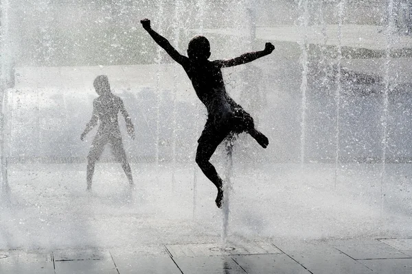 stock image Happy wet summer kids playing in water fountain