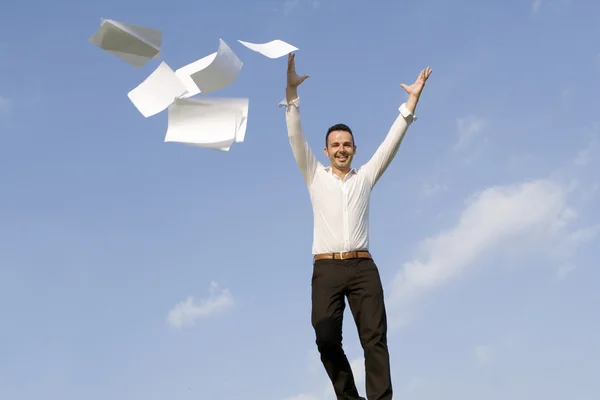 Happy business man throwing papers — Stock Photo, Image