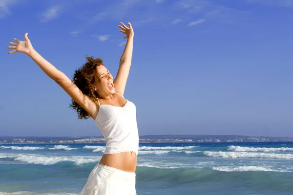 Happy girl arms raised on beach holiday vacation — Stock Photo, Image