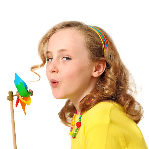 Pretty girl blowing windmill — Stock Photo, Image