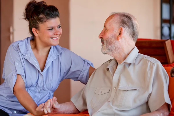 Anciano con enfermera cuidadora o nieta — Foto de Stock