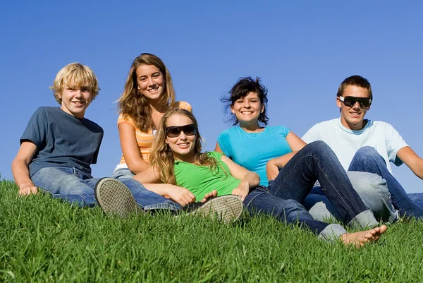 Group of happy teens or students in summer Royalty Free Stock Photos