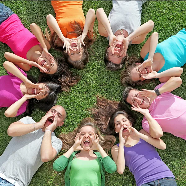 Group of kids or teens shouting or singing at summer camp Stock Picture