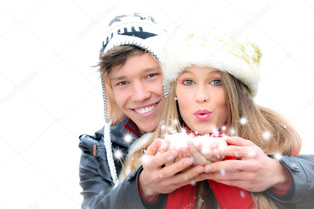 Fantasy happy winter couple blowing a christmas wish