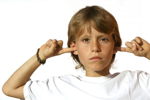 Rebellious child fingers in ears — Stockfoto