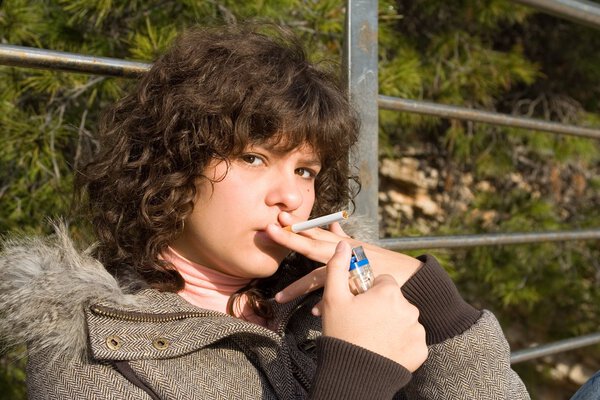 Teen girl smoking cigarette