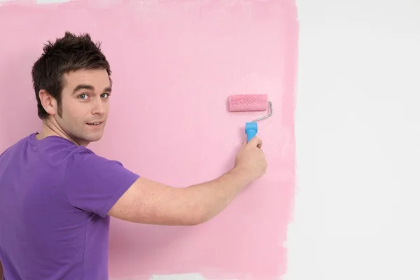 Young man painting decorating with roller brush — Stock Photo, Image