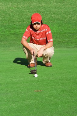 Young man playing golf calculating shot clipart