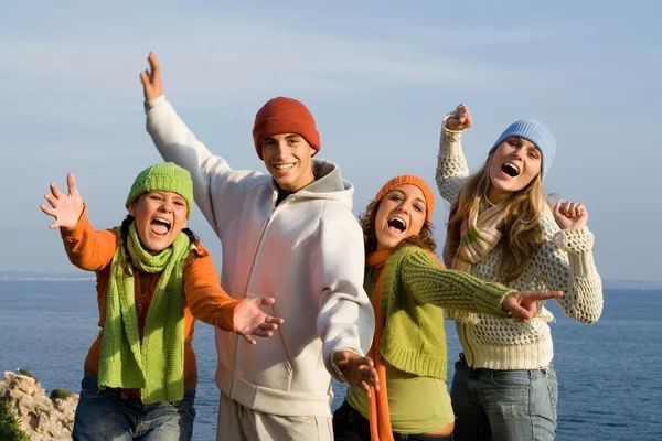 Группа счастливых улыбающихся подростков, поющих или кричащих — стоковое фото