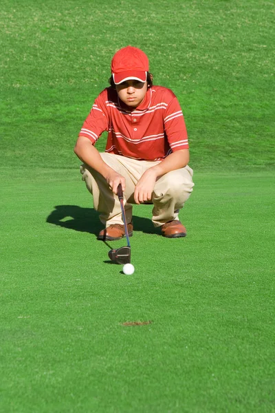 Genç bir adam oynarken golf atış hesaplanması — Stok fotoğraf
