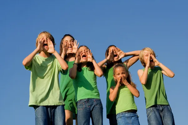 Az iskolás gyerekek kiabálva, éljenző, vagy énekelni boldog csoport — Stock Fotó