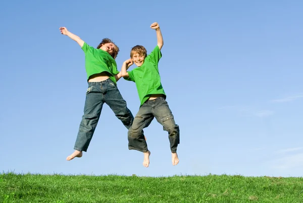 Happy winning kids jumping in celebration Stock Image