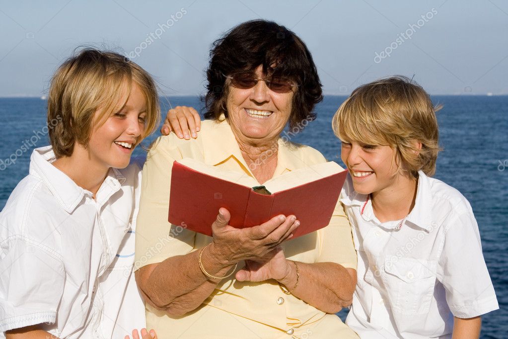 Grandmother, reading book to grandchildren