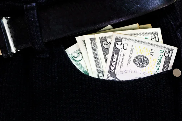 Billete de dólar en un bolsillo negro —  Fotos de Stock