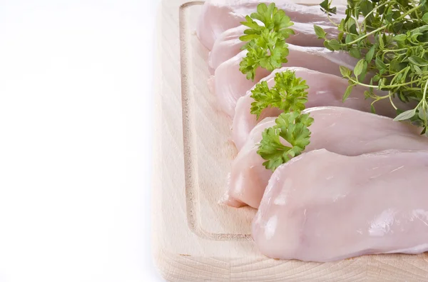 Raw chicken breasts on chopping board — Stock Photo, Image