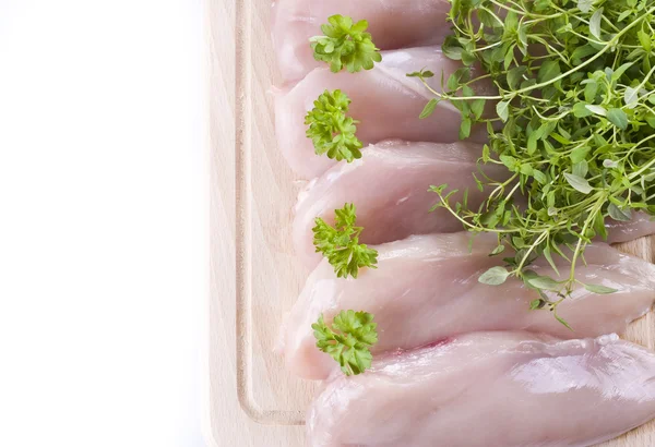 Raw chicken breasts on chopping board — Stock Photo, Image