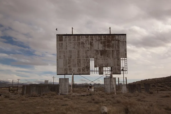 老弃置汽车电影院在多云的日子沙漠上 — 图库照片